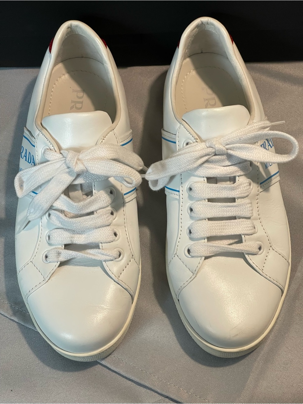 Prada White Leather Sneakers with Blue Logo Detail